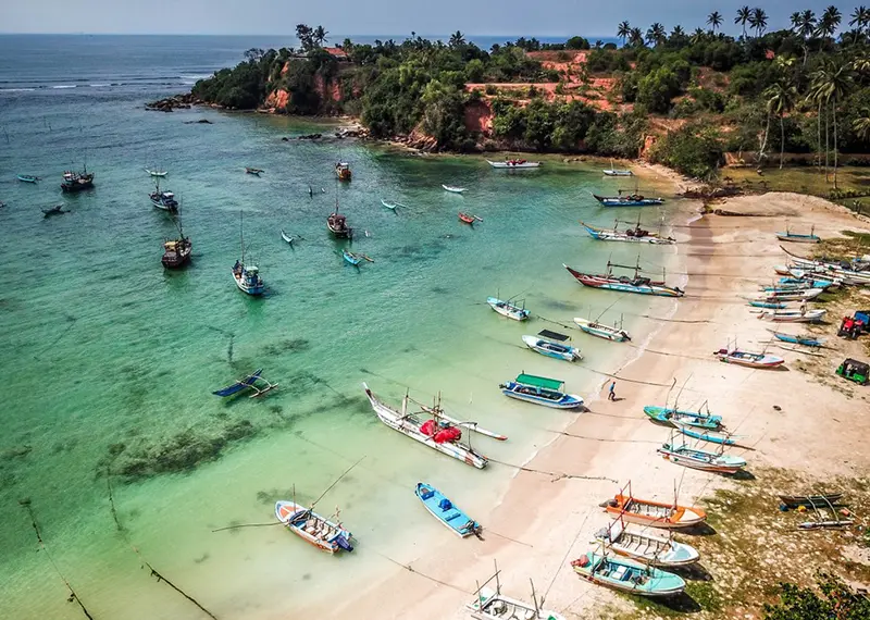Tourists visit this beautiful tropical fishing bay during their coastal holiday adventures