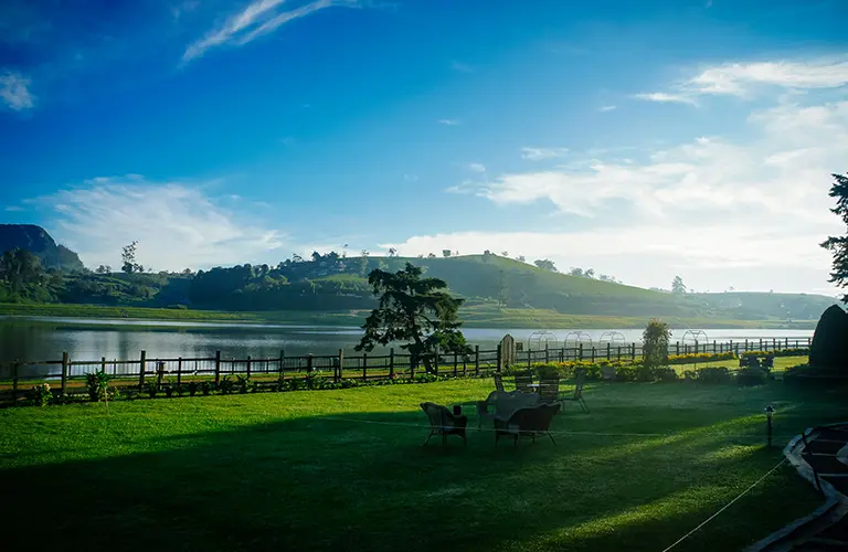 A peaceful lakeside garden with views of the rolling tea estates, a relaxing hill country retreat arranged by Universal Ceylon Travels