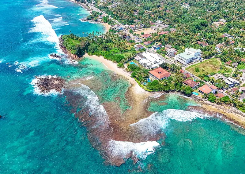 Aerial view of a beautiful tropical beach with clear turquoise coastal waters