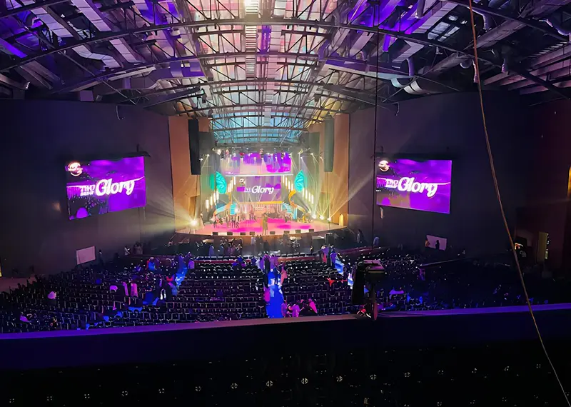 View of a large indoor auditorium stage lit for a live event
