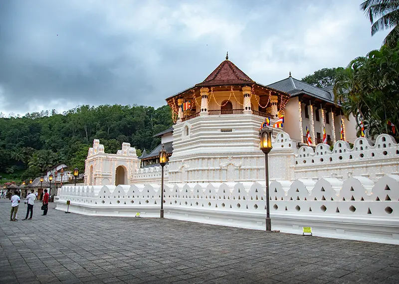 The illuminated white Temple of the Tooth Relic in historic Kandy town