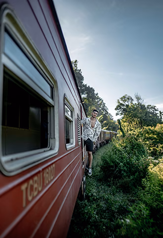 A tourist experiencing the iconic hillside train journey, a must-do adventure for anyone booking Australia to Sri Lanka travel