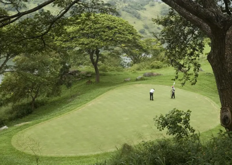 Two golfers play on a putting green at Victoria Golf Resort Sri Lanka