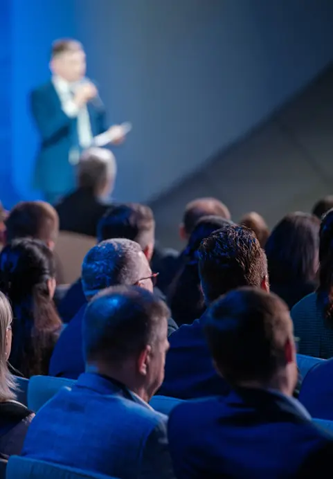 Business professionals listening attentively to a keynote speaker at a corporate conference on The Island Pulse - Corporate Event & Adventure Tour